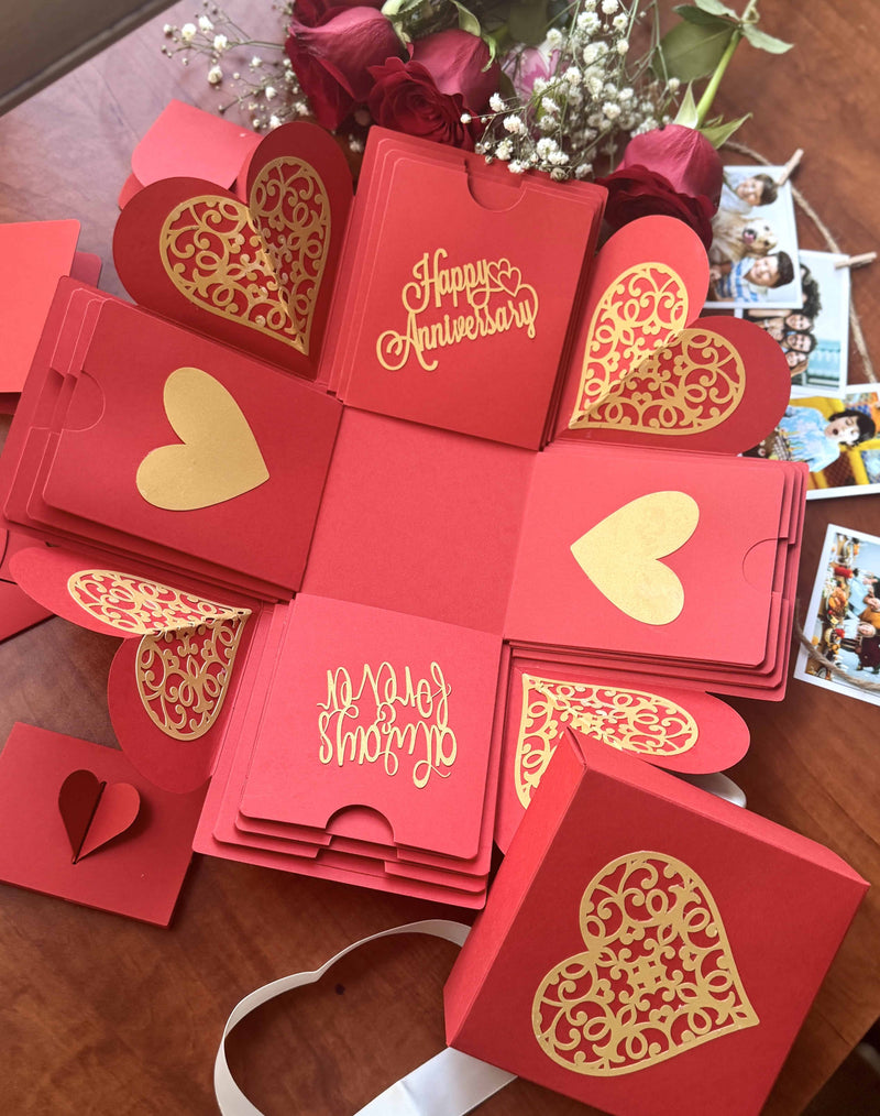 Red anniversary explosion box with photo string decoration - Table top view