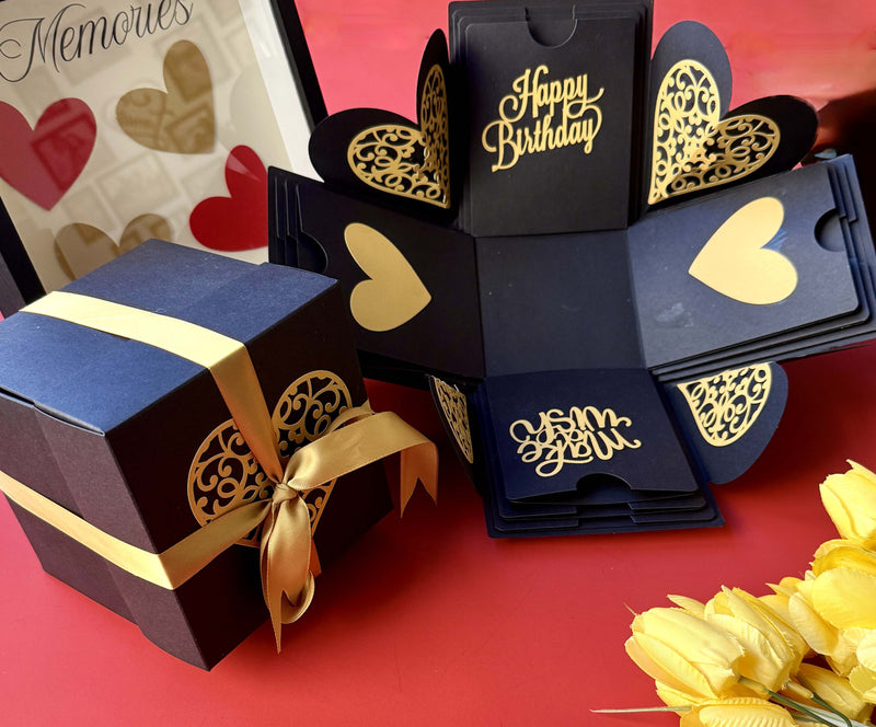 Black and gold birthday explosion gift box wrapped with a satin ribbon, ready for the big reveal