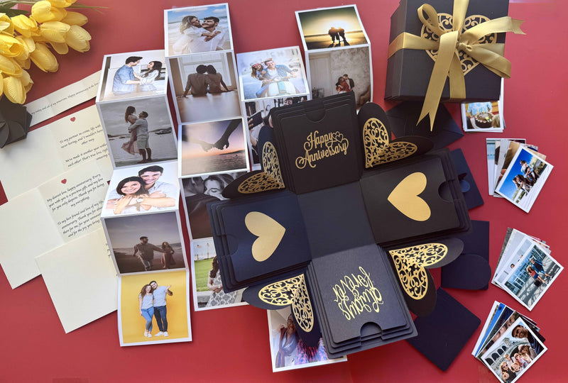 Black and gold explosion gift box with pull-out photo albums revealing couple memories