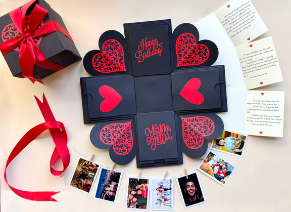 Top view of black red birthday explosion gift box with layered square panels