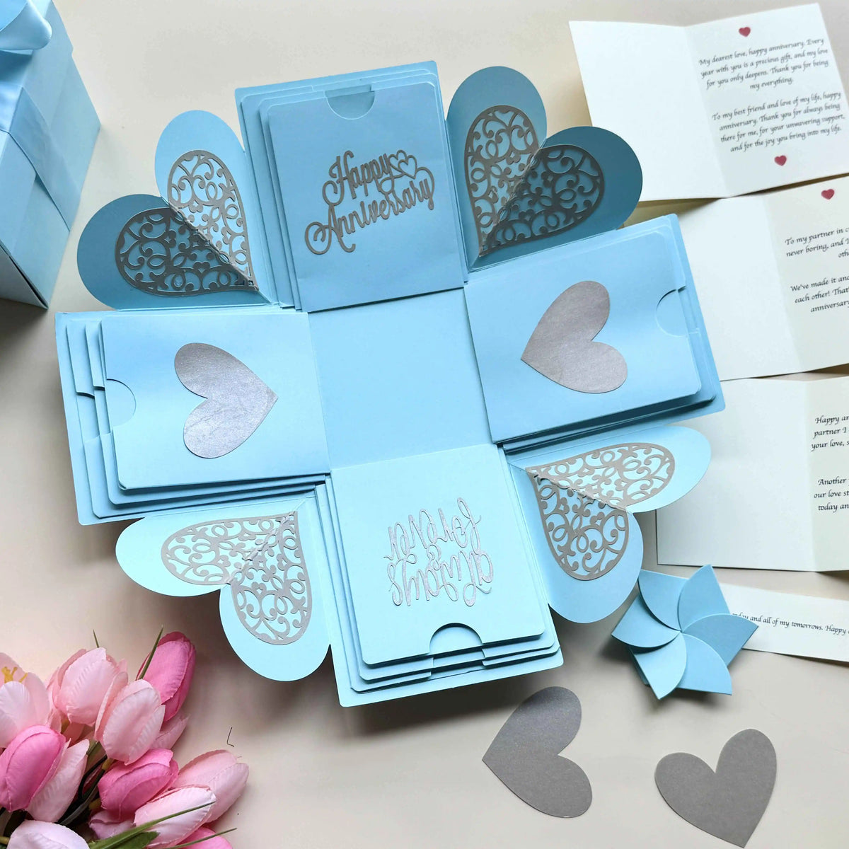 Close-up shot of blue explosion gift box highlighting personalized message cards