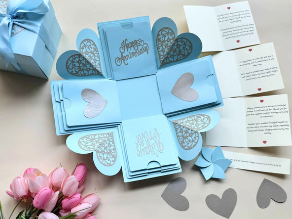 Close-up shot of blue explosion gift box highlighting personalized message cards