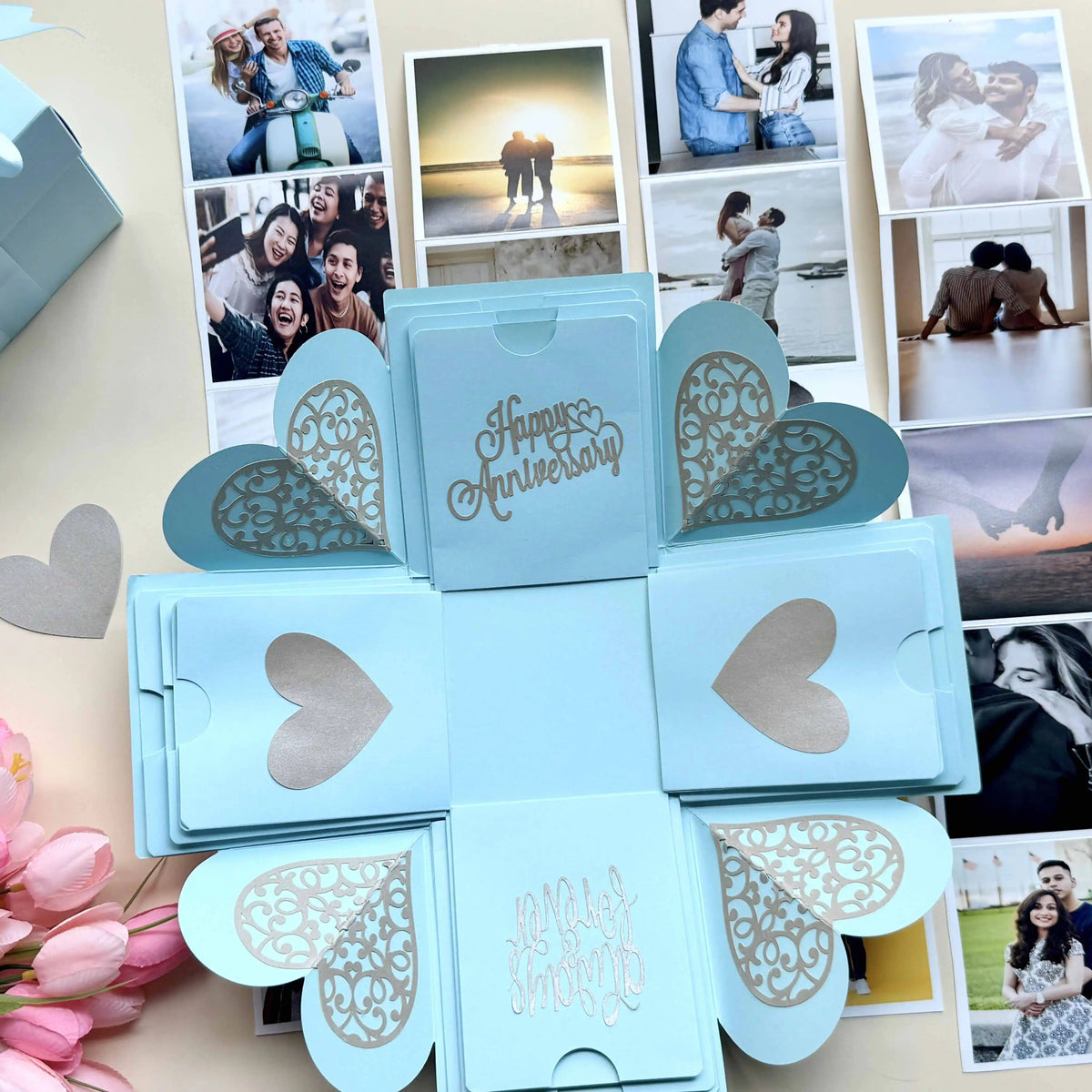 Blue anniversary explosion gift box opened flat, showing photos and message cards