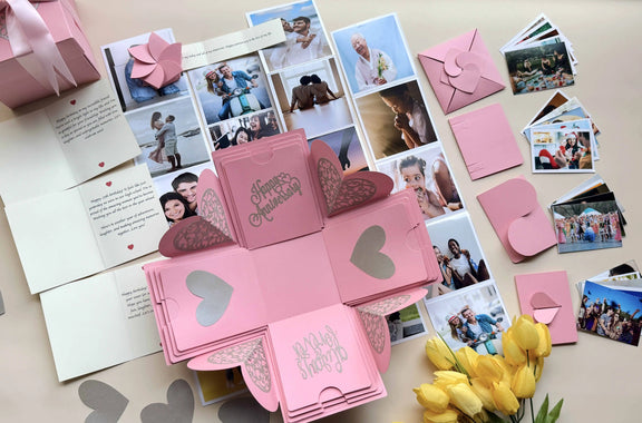 Angled view of open pink explosion gift box with photos on all four panels