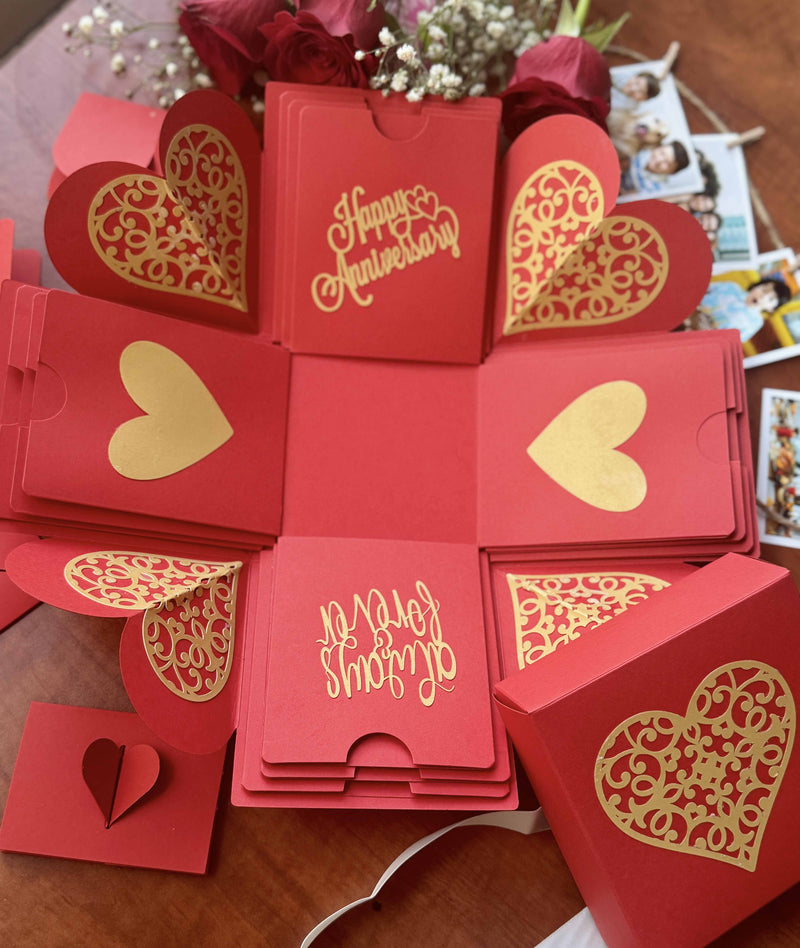 Red anniversary explosion box with all the product contents inside 