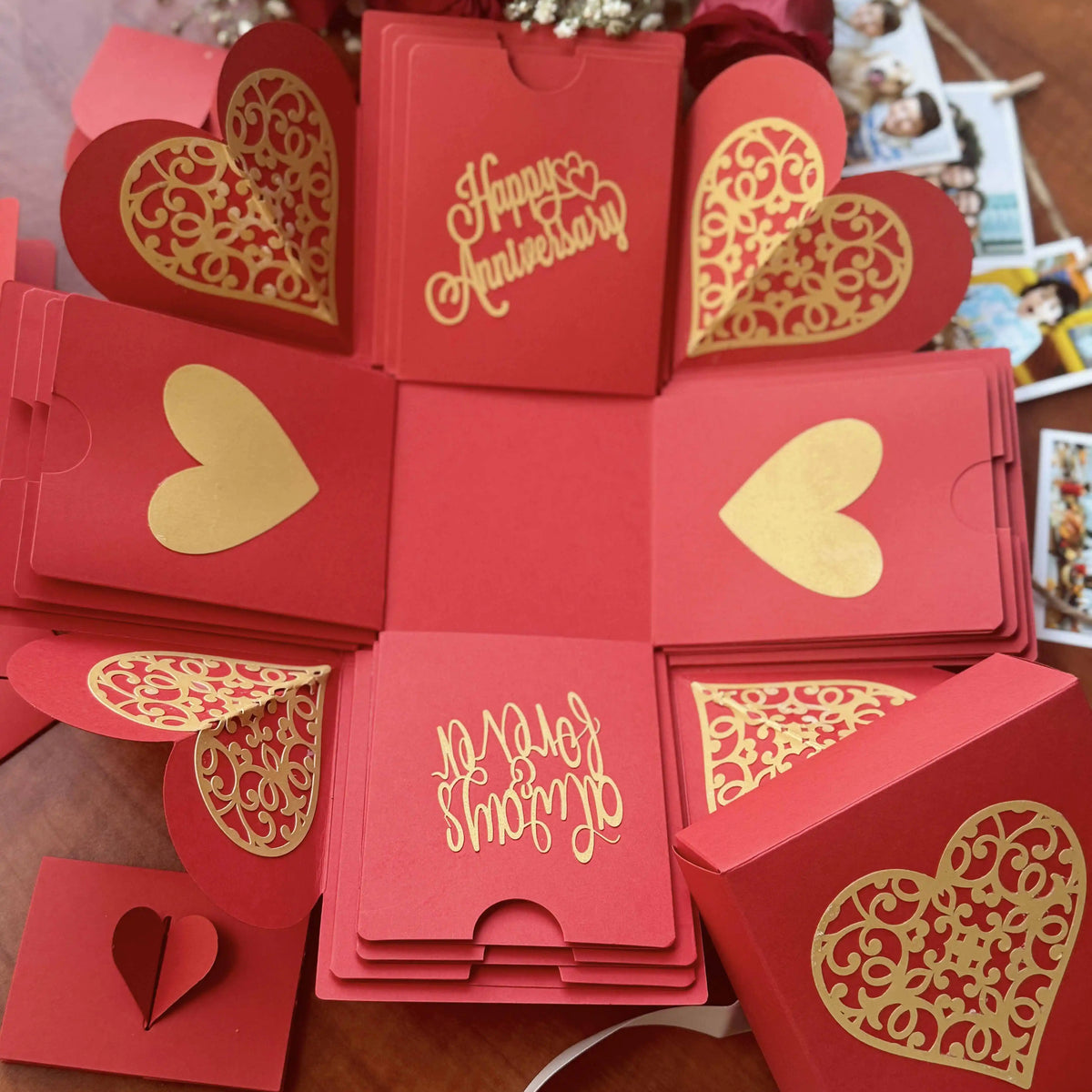 Flat-lay of red anniversary explosion gift box with customized messages