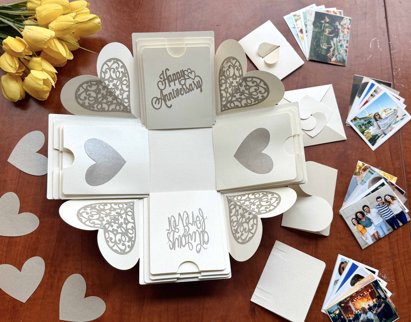 Explosion gift box for anniversary with wallet-size photos kept inside a folded pockets. Top view with the gift box open. 