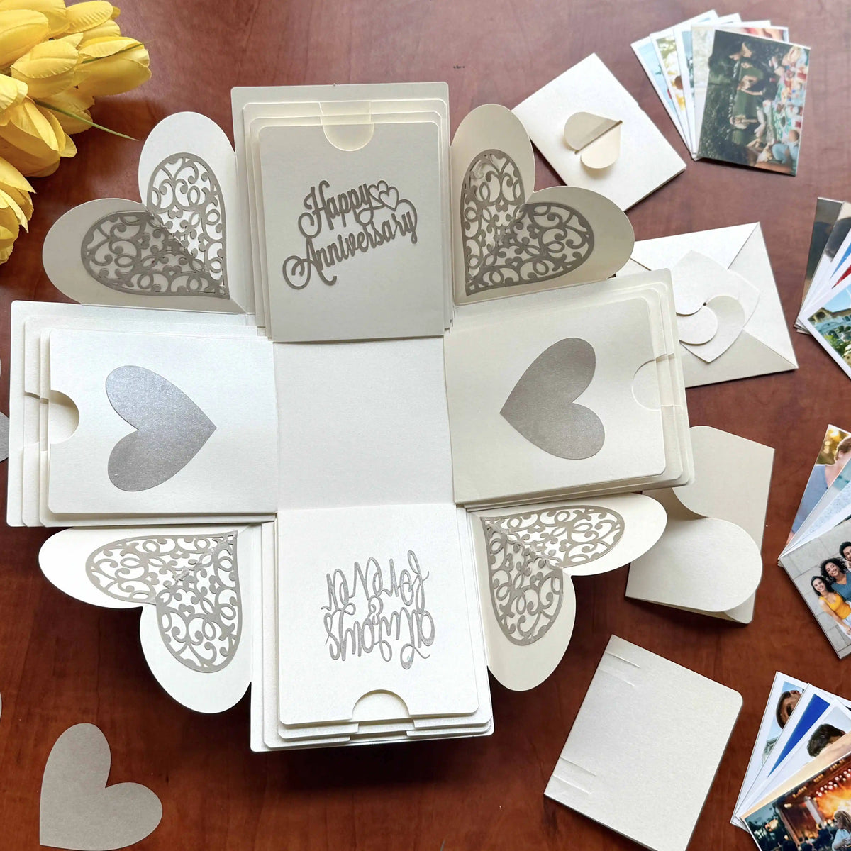 Angled view of open white explosion gift box with photos on all four panels