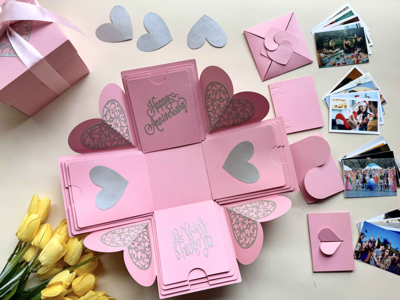 Explosion gift box for anniversary - Pink color with wallet-size photos customized and organized in cute folders- side angle with decorative hearts