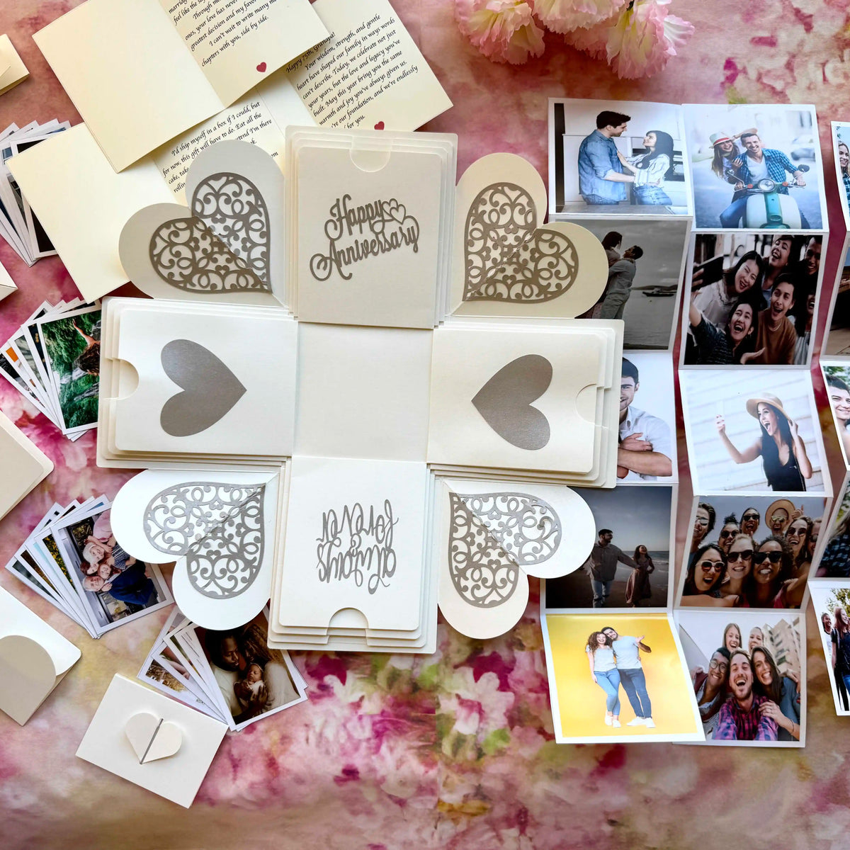 White anniversary explosion gift box opened flat, showing photos and message cards