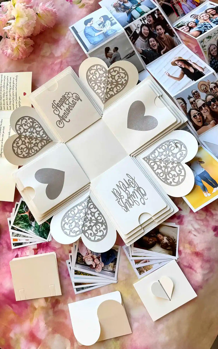 Angled view of open white explosion gift box with photos on all four panels