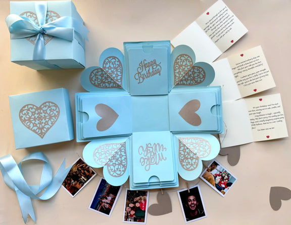 Blue birthday explosion gift box opened displaying custom photo inserts