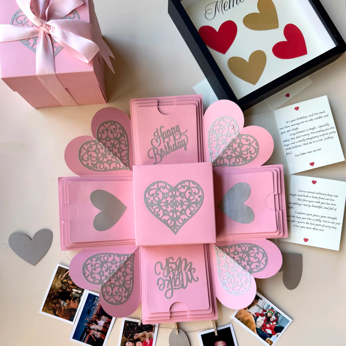 Pink birthday explosion gift box unopened, angled shot with ribboned lid