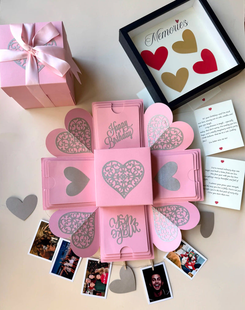 Pink birthday explosion gift box unopened, angled shot with ribboned lid