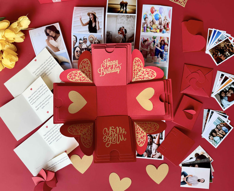 Red birthday explosion box highlighting a message layer, customized pull-out photo albums, and personalized wallet photos.