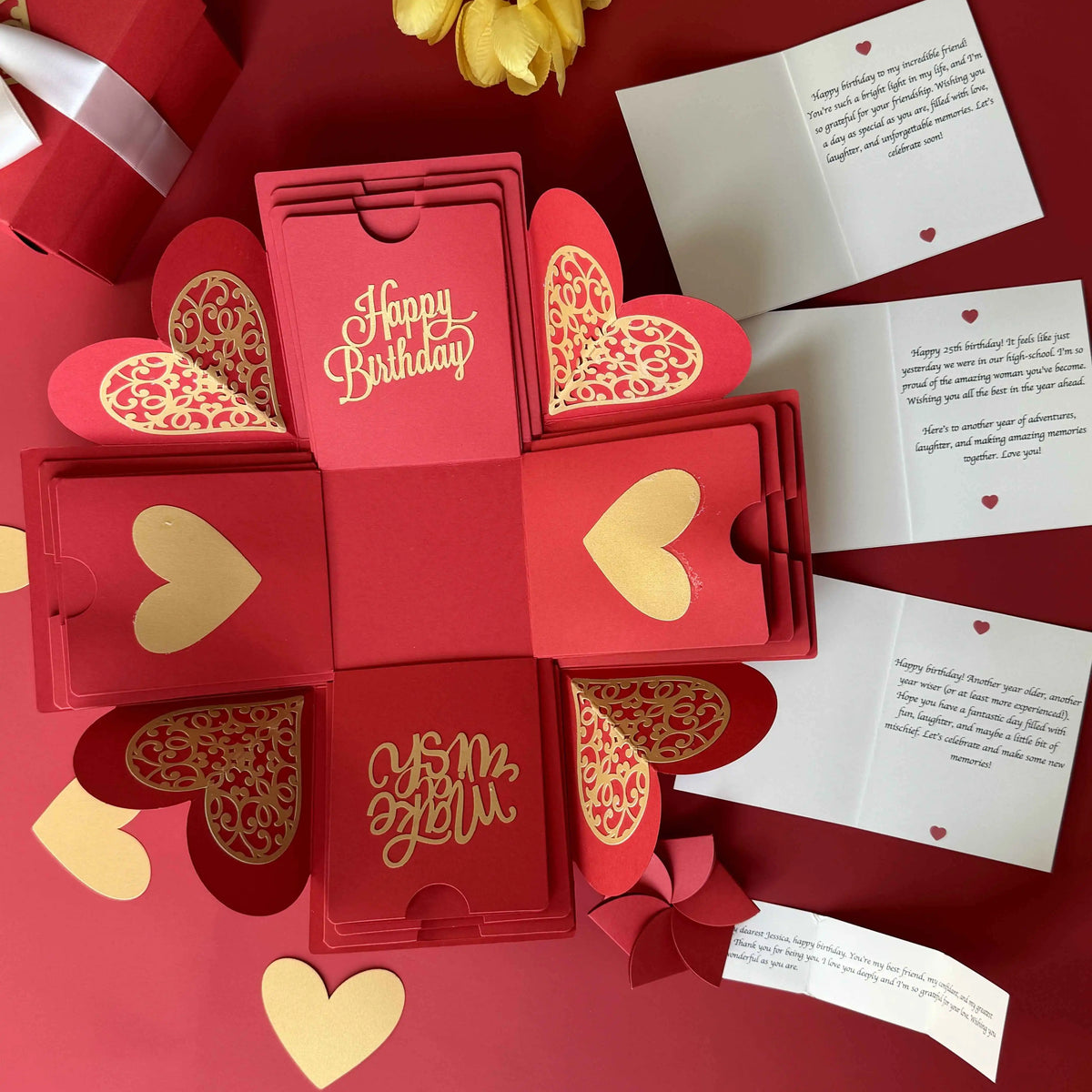 Angled view of red birthday explosion gift box highlighting photos and message layers