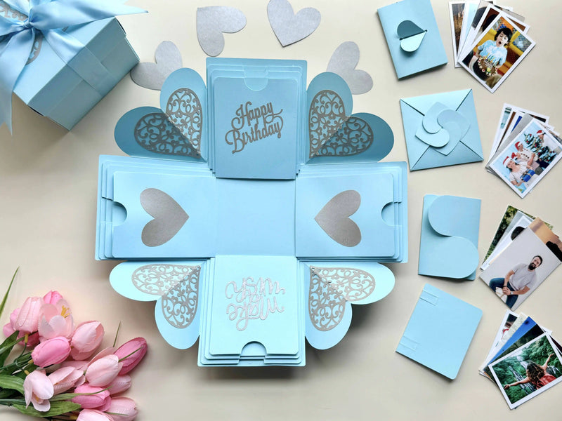 Close-up detail of blue birthday explosion gift box with customized polaroid photos
