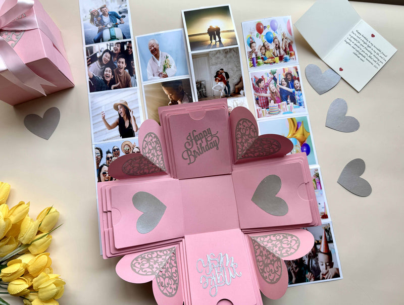 Explosion gift box for birthdays in pick color with pull-out customized square albums - flat-lay photography
