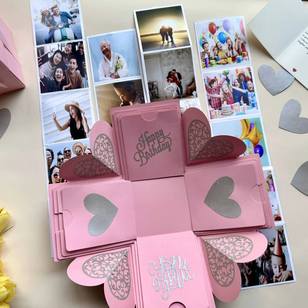 Pink birthday explosion gift box opened showing personalized message cards