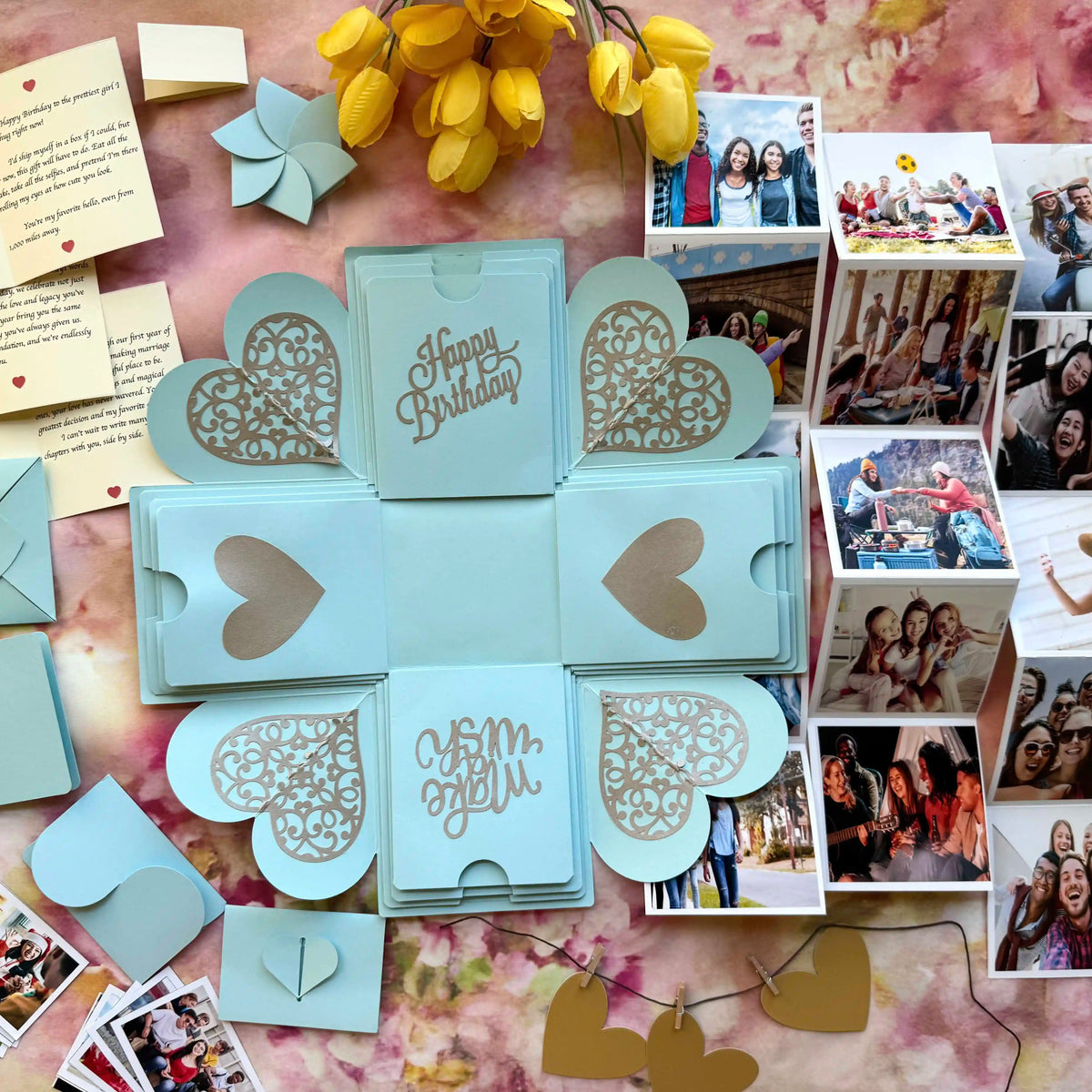 Blue birthday explosion gift box opened showing personalized message cards