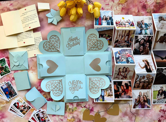 Blue birthday explosion gift box opened showing personalized message cards
