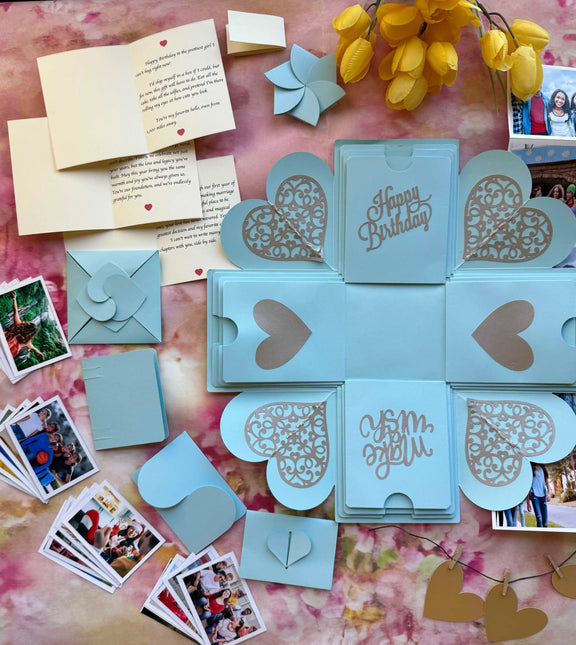 Top view of blue birthday explosion gift box with layered square design