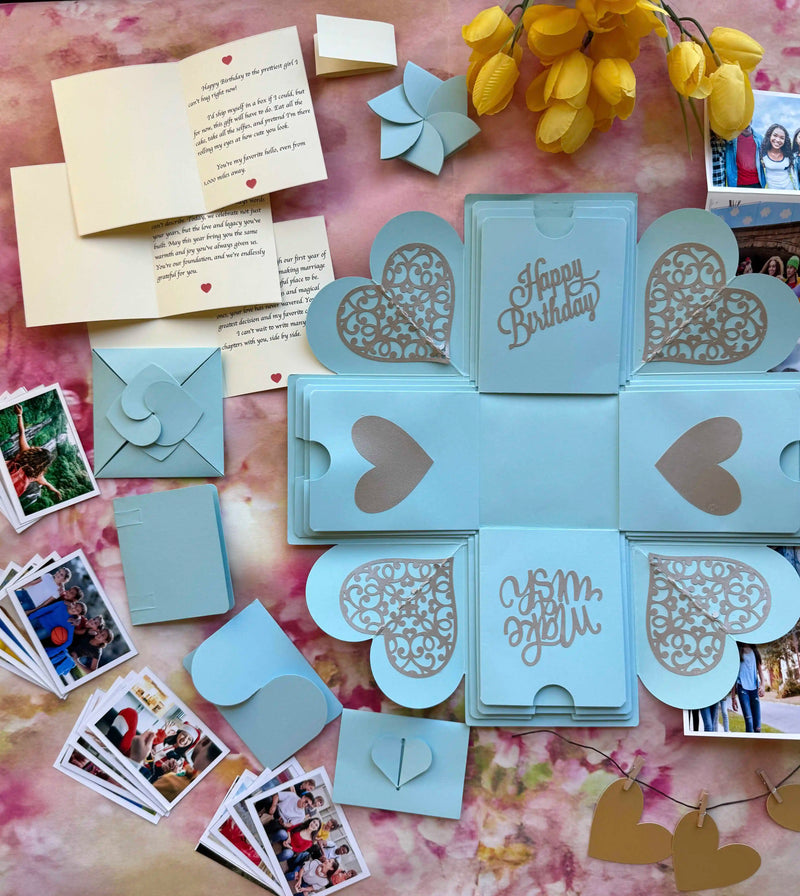 Top view of blue birthday explosion gift box with layered square design