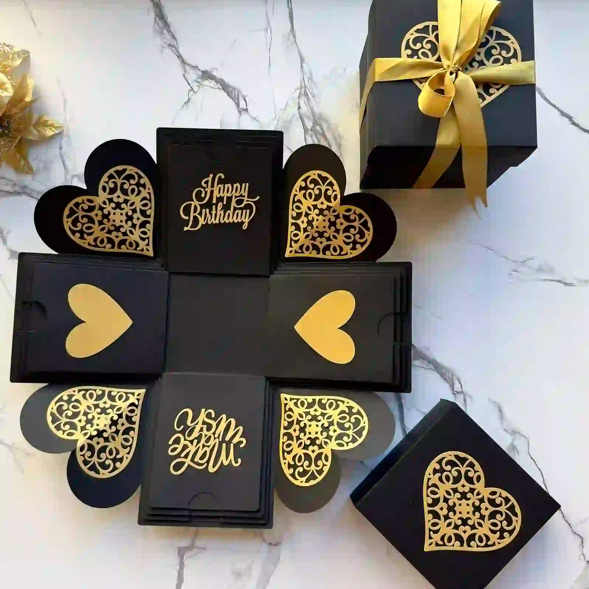 Top view of black and gold birthday explosion gift box before opening
