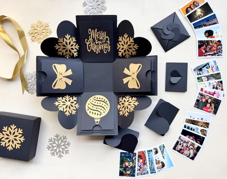 Angled shot of black Christmas explosion gift box in the mini surprise version.