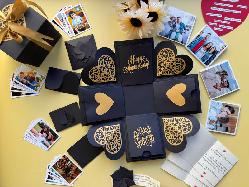 Open black explosion gift box showing photos arranged on all sides