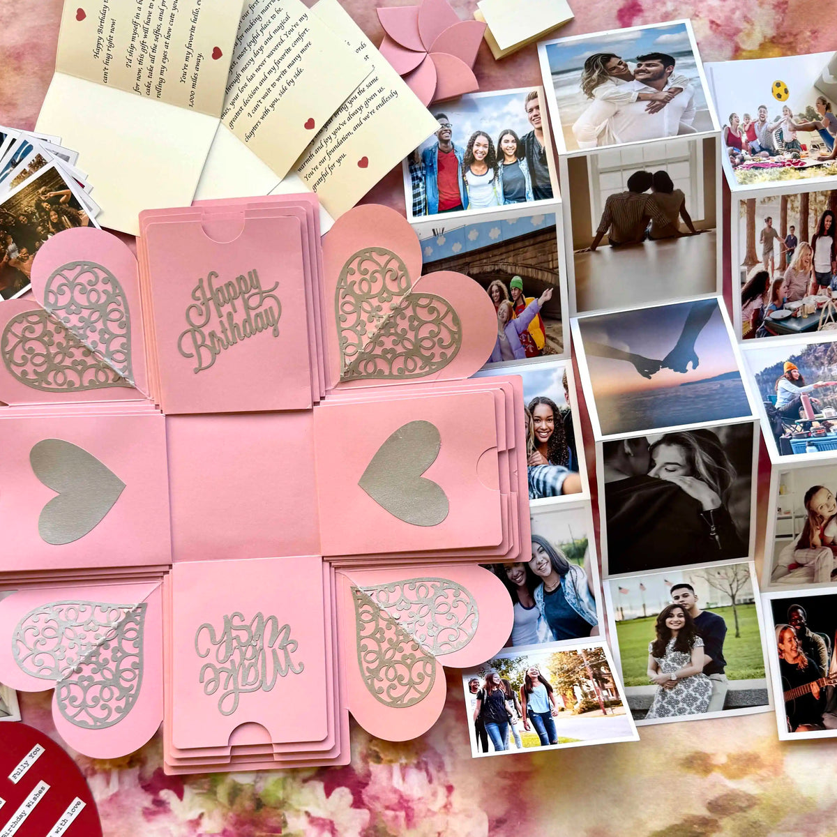 Pink birthday explosion gift box opened displaying custom photo inserts