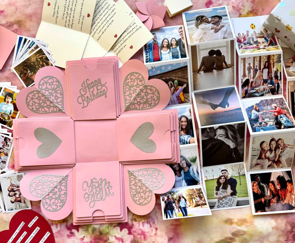 Pink birthday explosion gift box opened displaying custom photo inserts