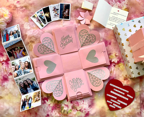 Top view of pink birthday explosion gift box with layered square panels