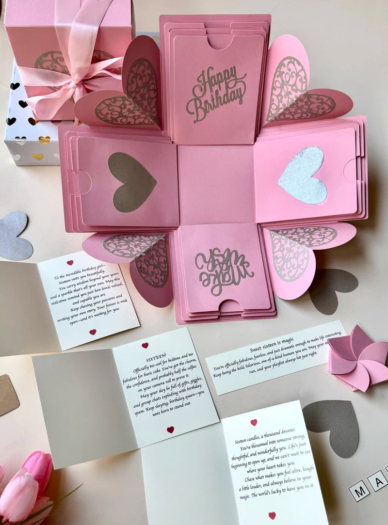 Close-up detail of white birthday explosion gift box showing paper layers and craftsmanship