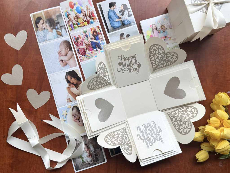 Explosion gift box for Mother's day white color - with customized pull-out albums and photos - product catalog photo - flat-lay photo decorated with flowers and hearts 
  