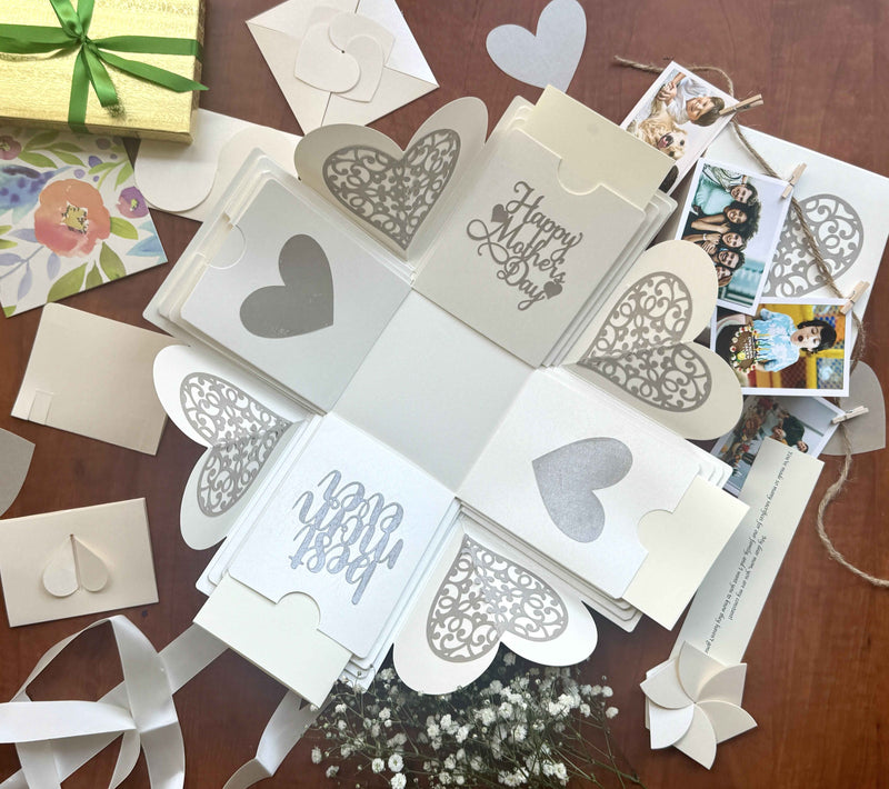 White Mother's Day explosion box featuring a message layer, customized pull-out photo albums, and personalized wallet-size photos.