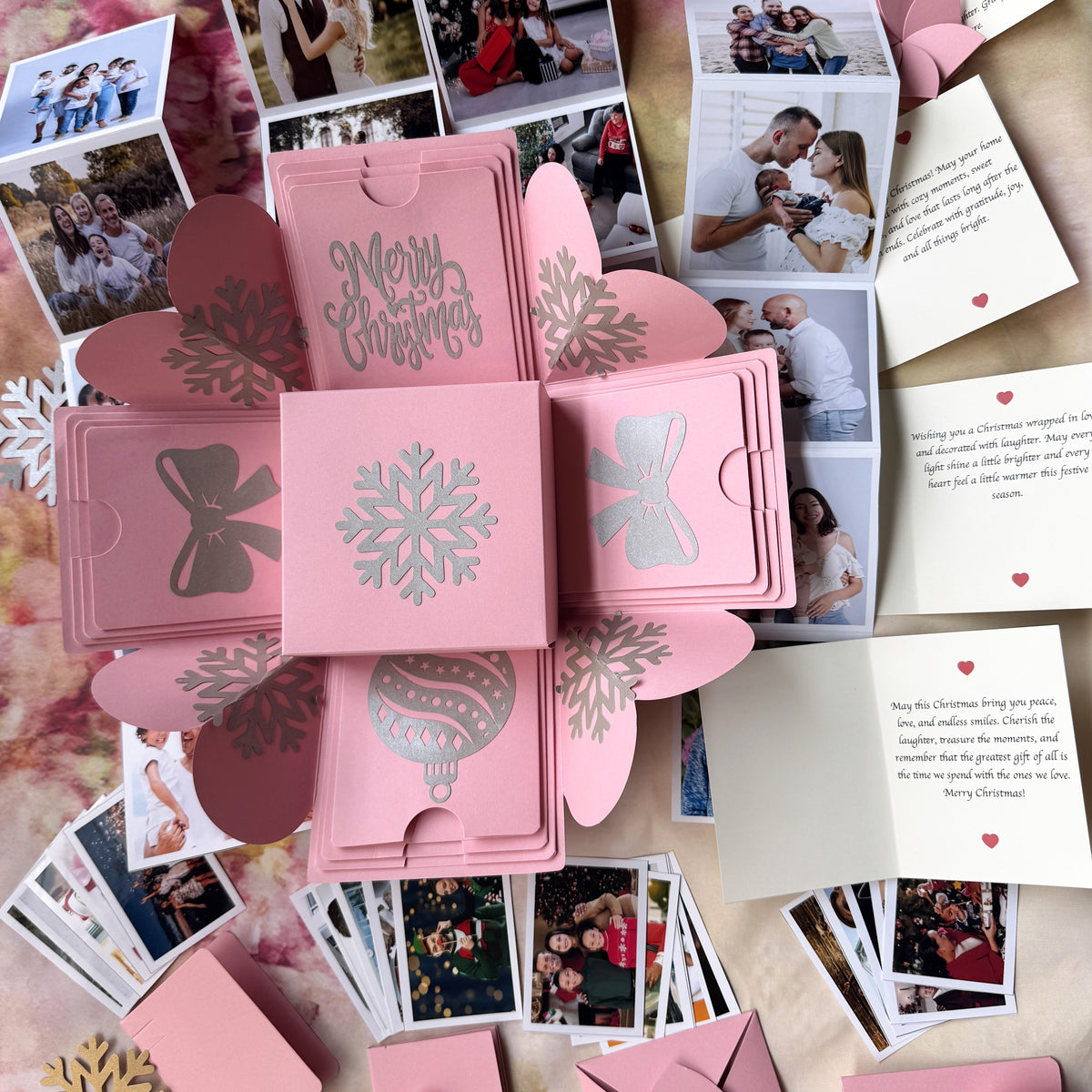 Top-view hero image of pink Christmas explosion gift box with closed lid.