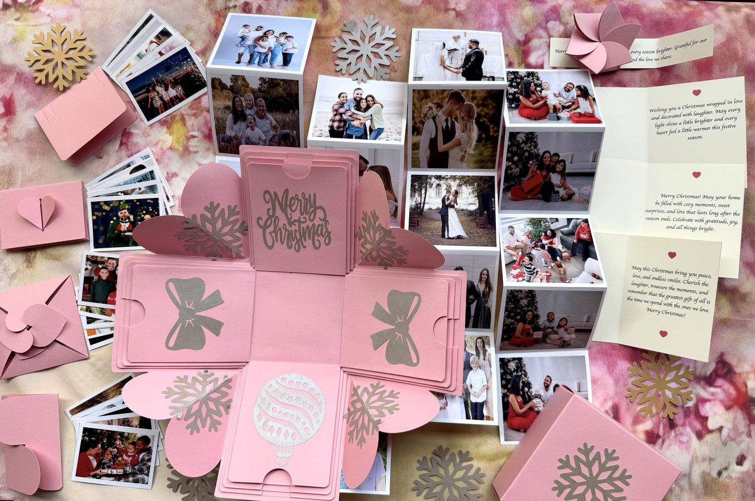 Top-view pink Christmas explosion gift box showing extended pull-out photo albums.