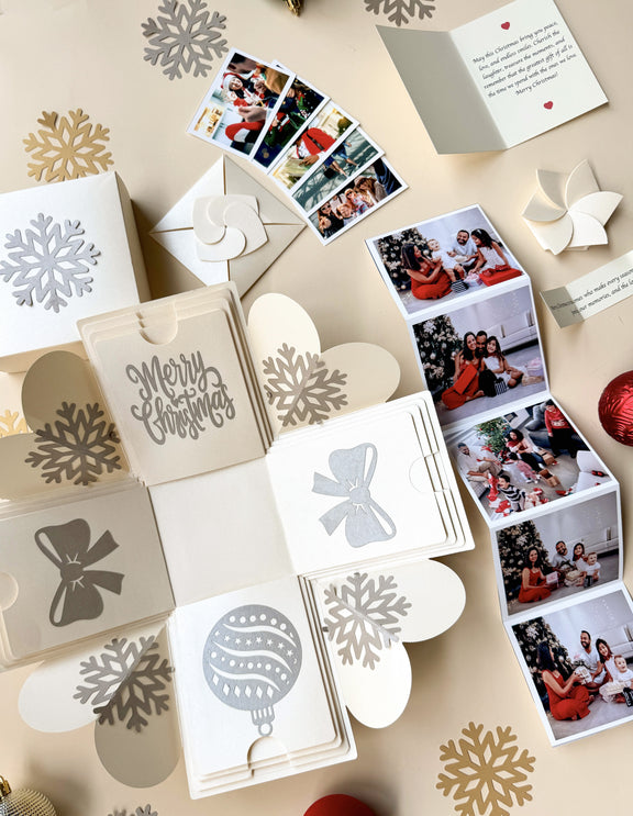 Top-view explosion gift box showing extended pull-out photo albums.