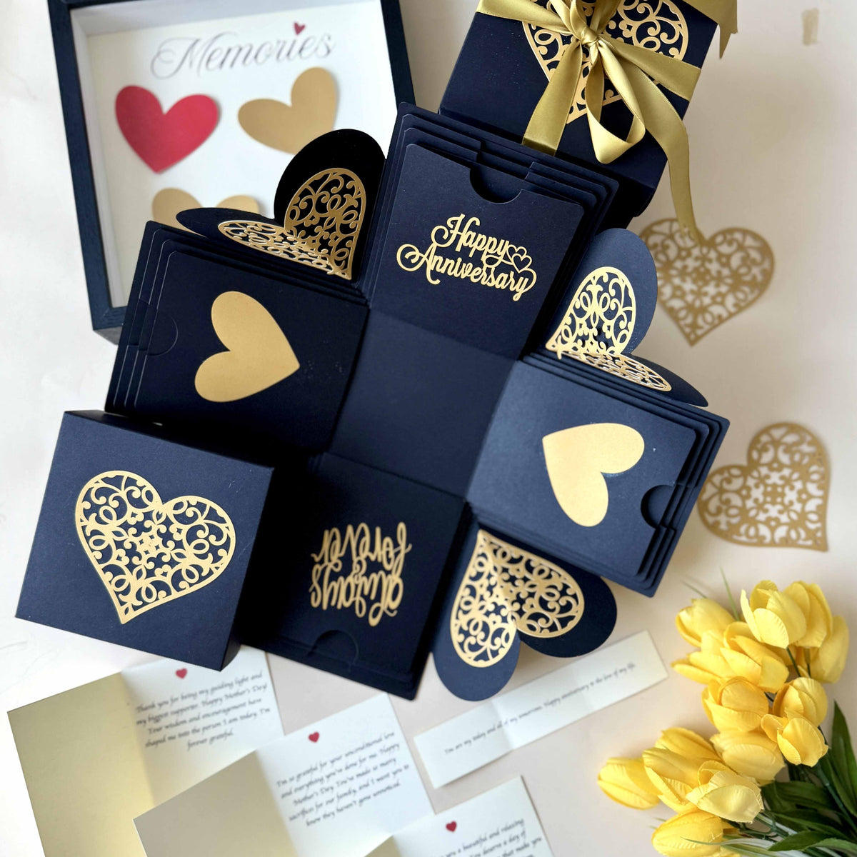 Close-up of message layer inside black and gold explosion gift box with personalized anniversary note