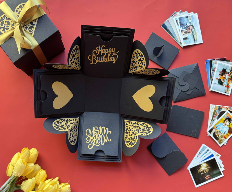 Black and gold explosion box with wallet-size photo prints—perfect for sharing birthday memories