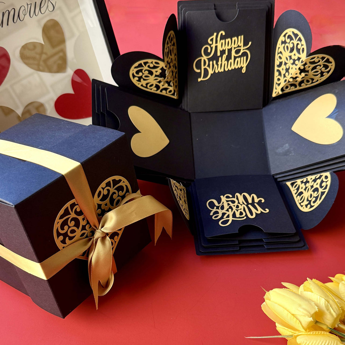 Black and gold birthday explosion gift box wrapped with a satin ribbon, ready for the big reveal