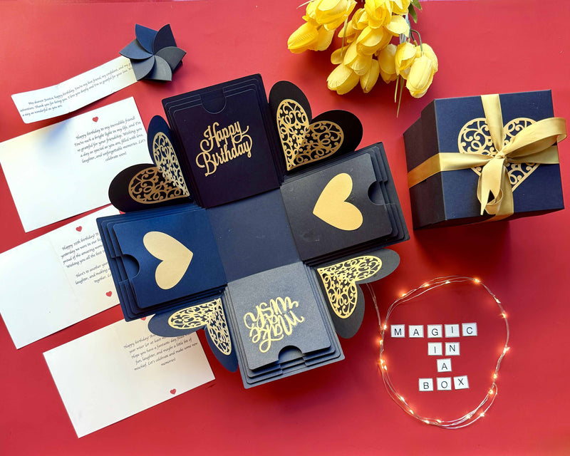 Close-up of heartfelt birthday messages inside a luxurious black and gold explosion box