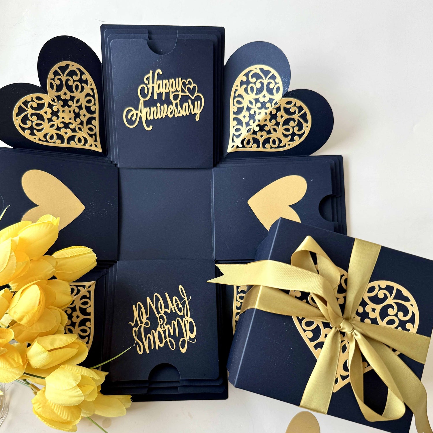 Black and gold anniversary explosion gift box with elegant ribbon wrapped, close up view