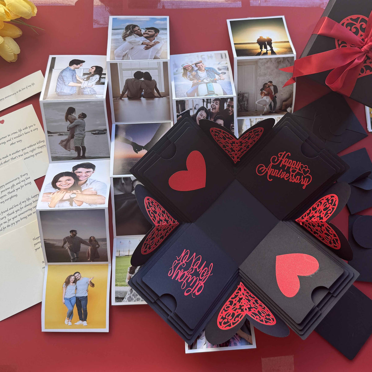 Open black and red explosion box for anniversary, revealing personalized photo layers and romantic messages
