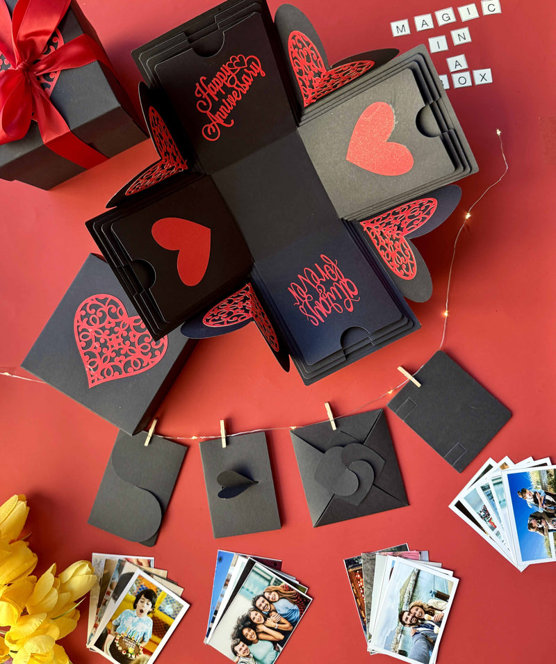 Black and red explosion box featuring wallet-size photo prints—ideal for celebrating shared memories