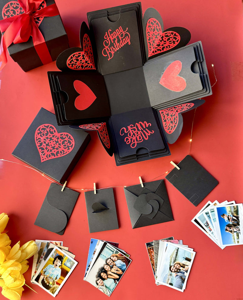 Black and red explosion birthday gift box with wallet-sized photo prints displayed beautifully