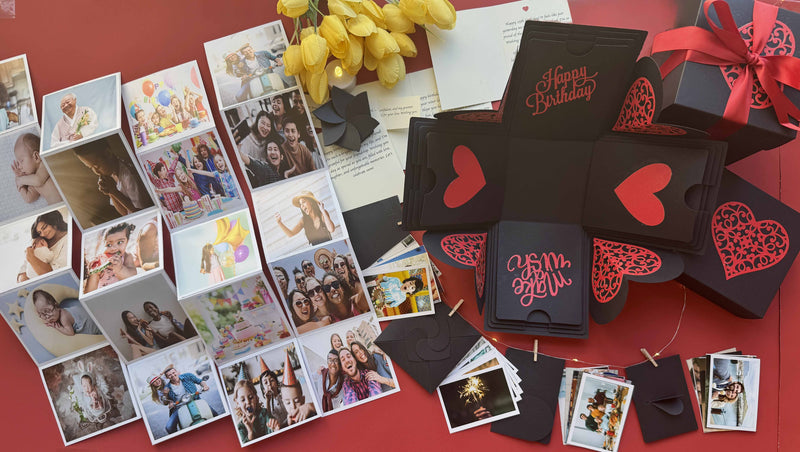 Black and red explosion birthday gift box with wallet-sized photo prints displayed beautifully