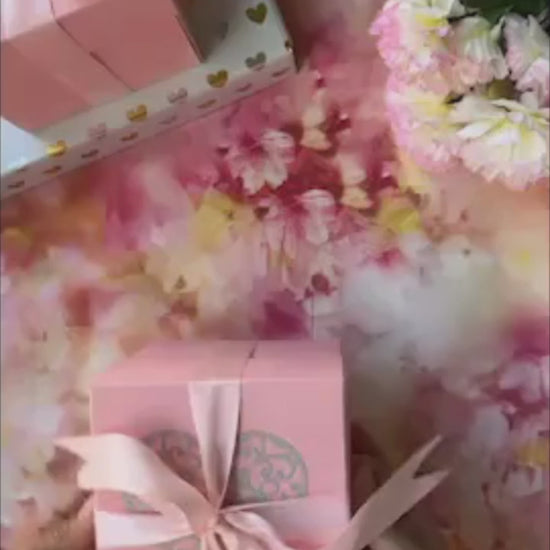 Product demo video of Pink anniversary explosion gift box opened flat, showing photos and message cards
