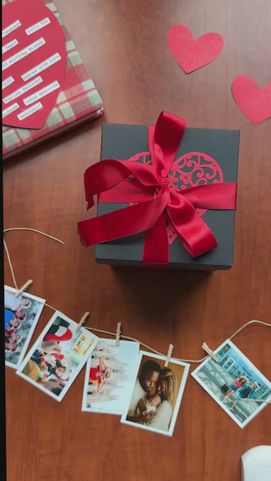 Video showing a black and red explosion gift box unfolding layer by layer, revealing photos, pull-out albums, and heartfelt message cards. The product demo highlights its customizable design and elegant craftsmanship, perfect for birthdays, anniversaries, and romantic gifting.